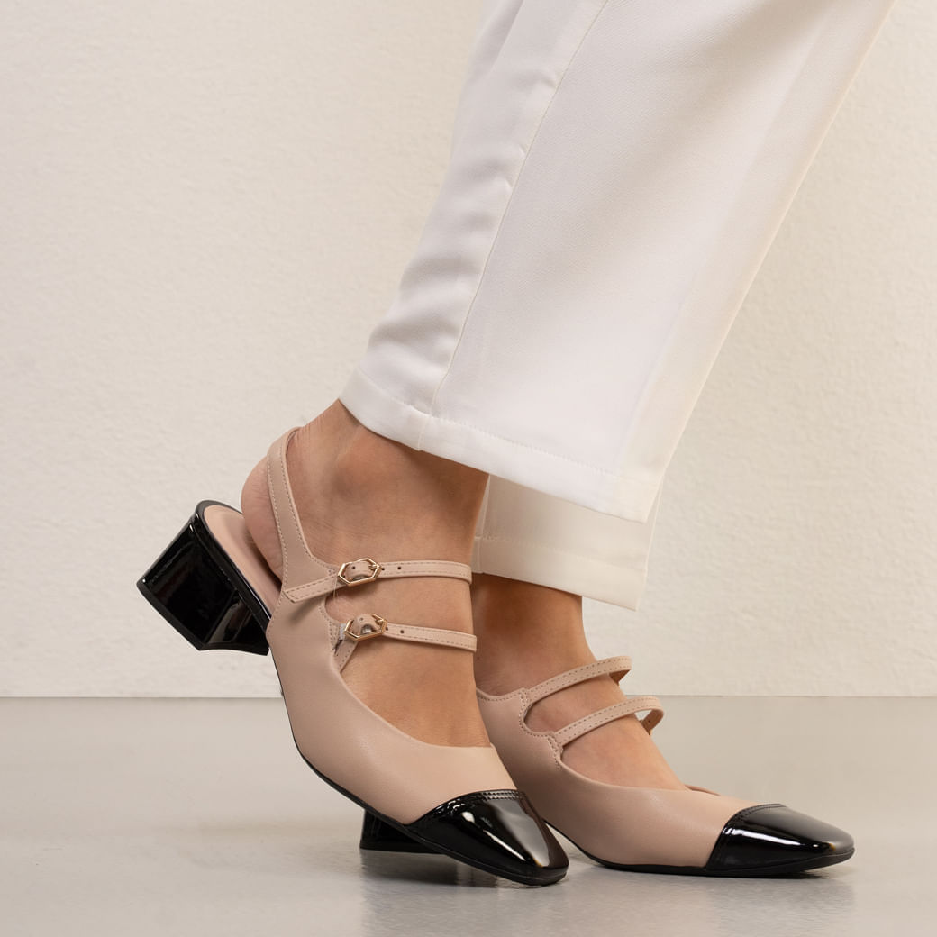 Close lateral do sapato Slingback feminino Bebece bege com biqueira preta em verniz e salto bloco brilho