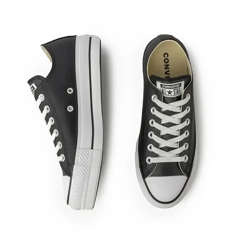 Tênis feminino plataforma preto All Star em ângulo 3/4 esquerdo mostrando perfil e cadarços brancos