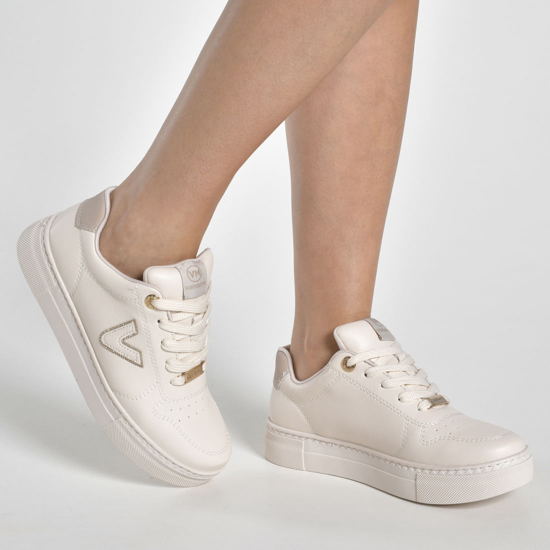 Tênis casual feminino Via Marte cor bege vista lateral com detalhes brancos e logo em relevo
