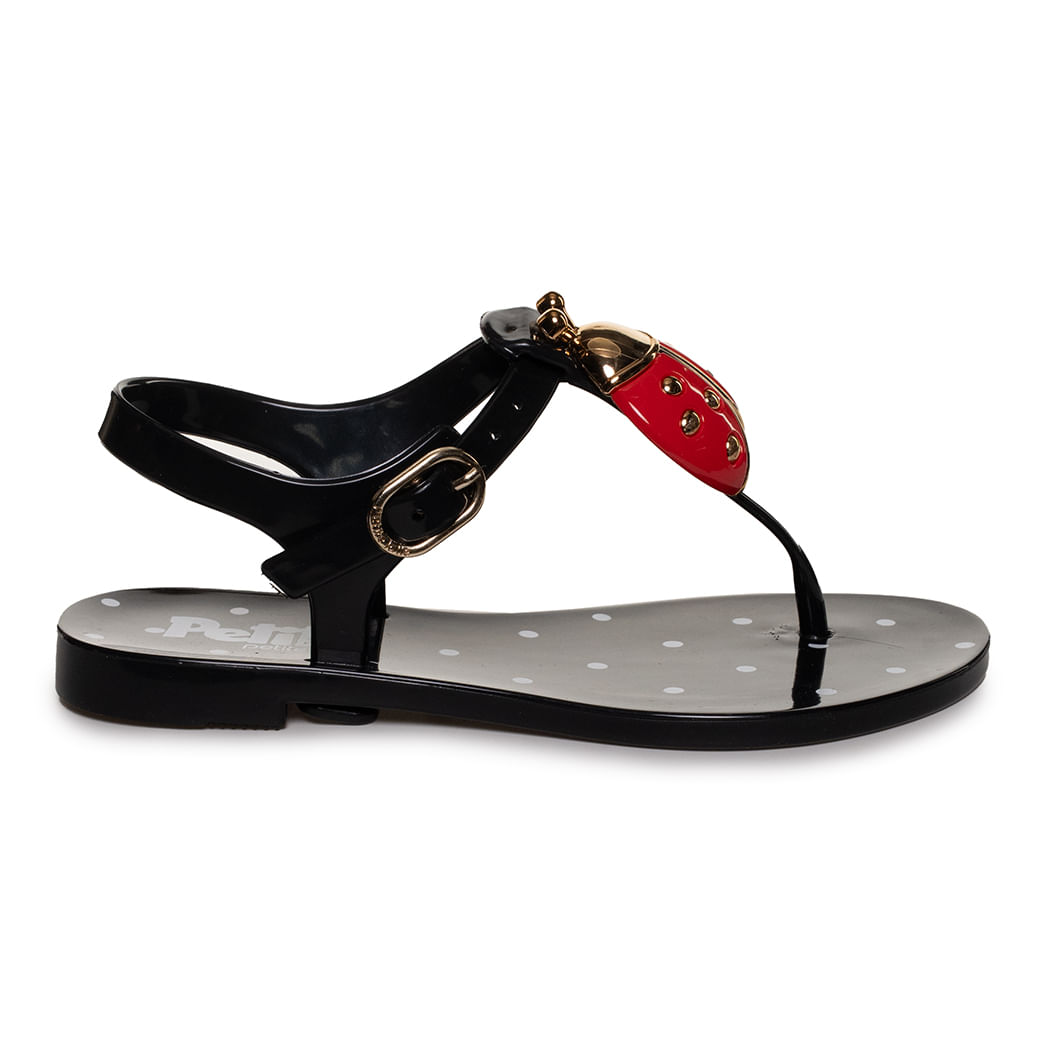 Sandália rasteira infantil preta em PVC com aplicação de joaninha vermelha e fivela dourada ajustável no tornozelo