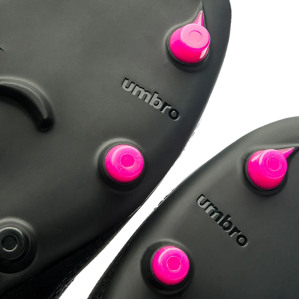 Detalhe do solado da Chuteira Umbro ADAMANT MASTER com pinos rosé e logo Umbro