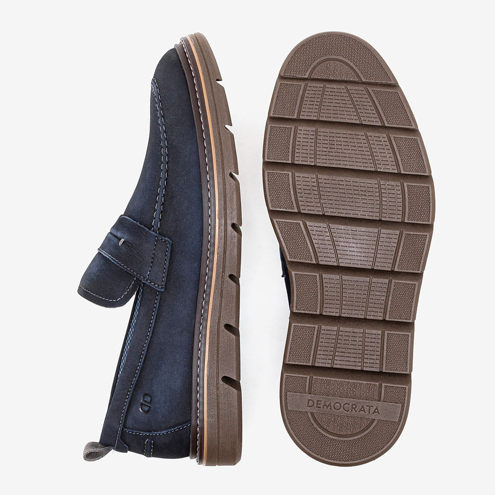 Sapato casual masculino e sola marrom com ranhuras para tração em fundo branco.