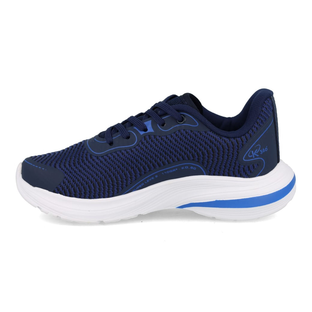 Tênis infantil Kidy em perfil lateral esquerdo mostrando malha respirável marinho e detalhes azul royal, solado branco alto com faixa azul.