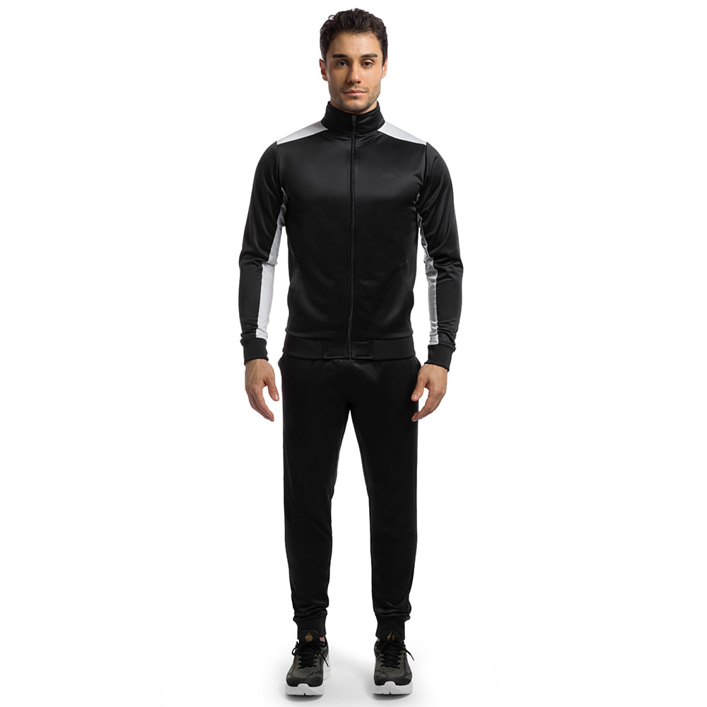 Homem vestindo agasalho esportivo preto Olympikus com zíper frontal e mangas longas